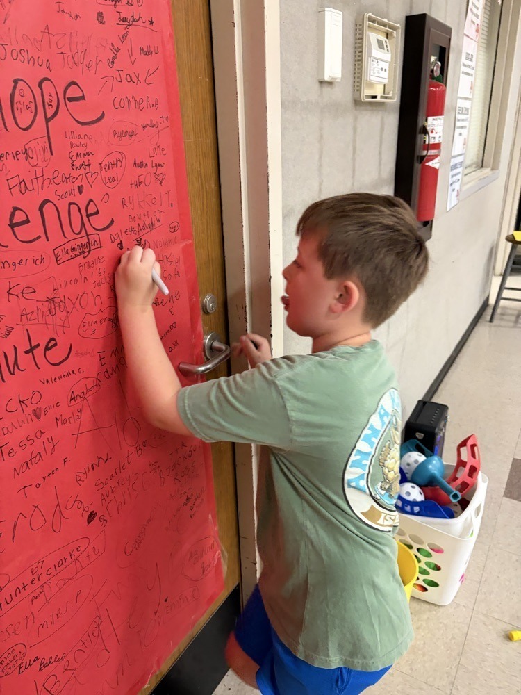 Westside elementary student signing jump rope poster