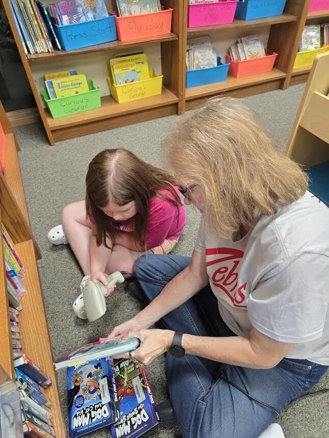 Elementary student learning about librarian duties.