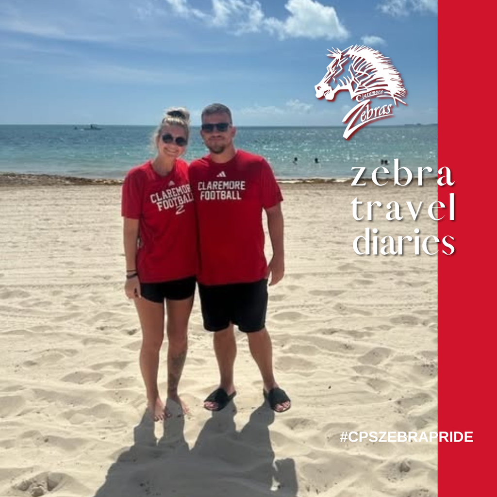 two people in claremore football logo tshirts on the beach