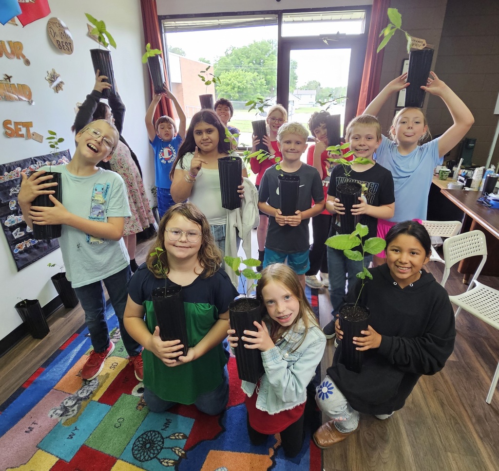 students holding plants