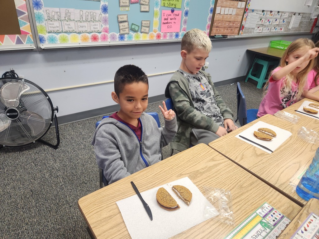 students practicing their fractions with oatmeal cream pies, they're cutting them and eating them too