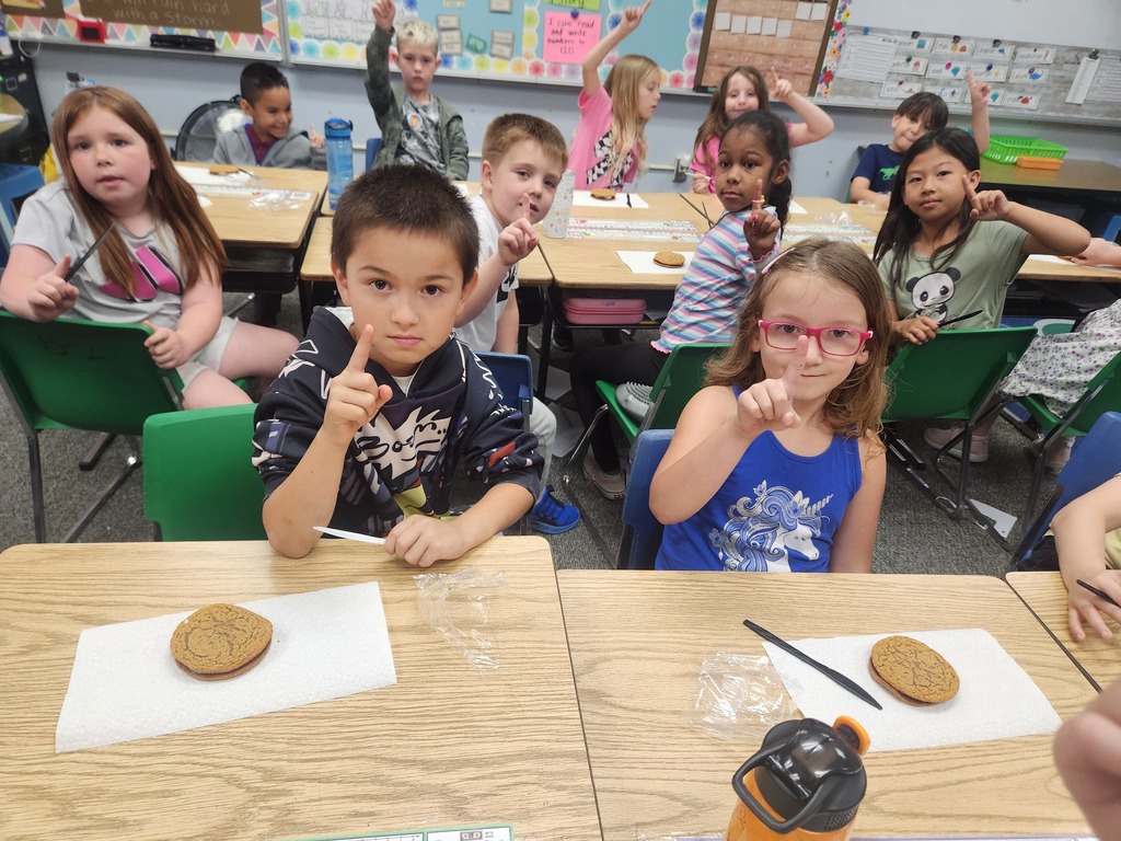 students practicing their fractions with oatmeal cream pies, they're cutting them and eating them too