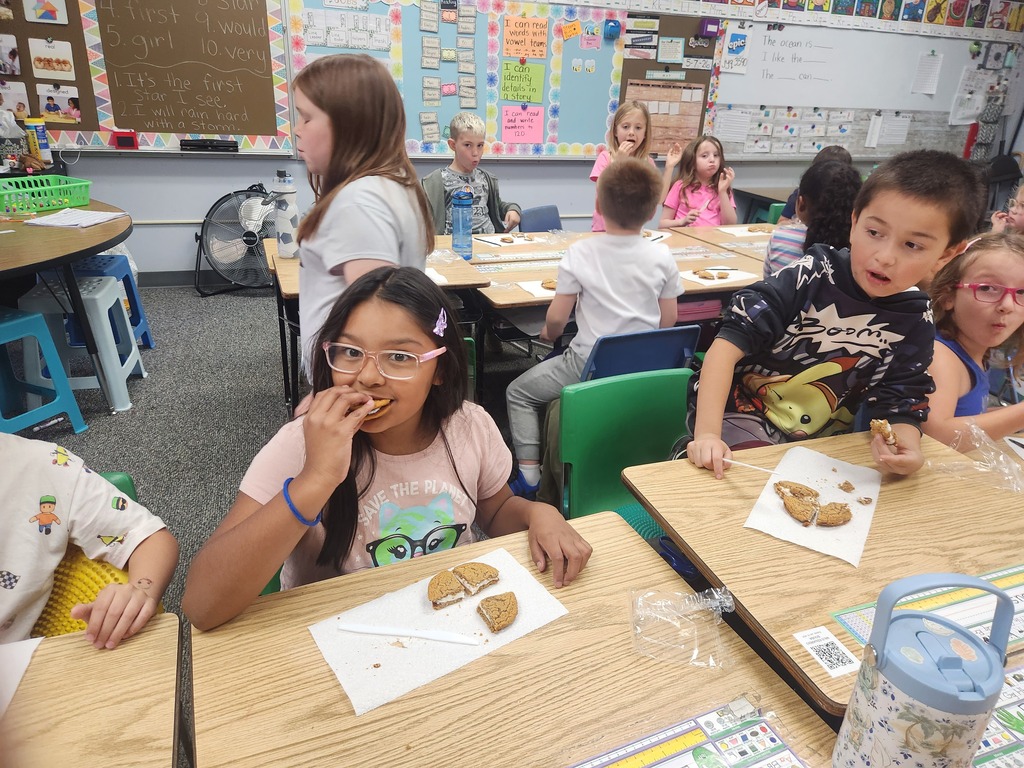 students practicing their fractions with oatmeal cream pies, they're cutting them and eating them too