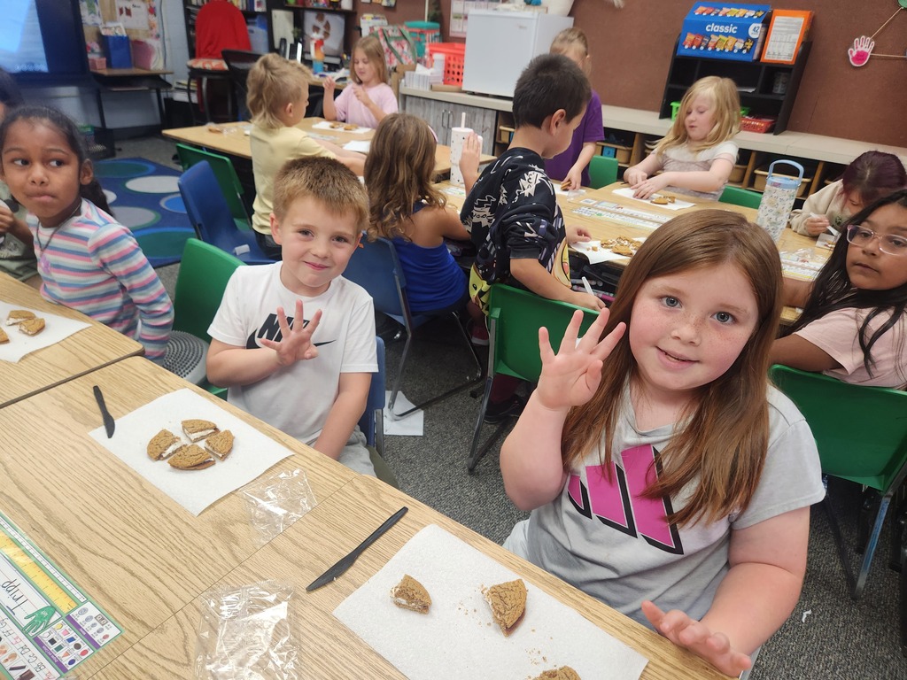 students practicing their fractions with oatmeal cream pies, they're cutting them and eating them too