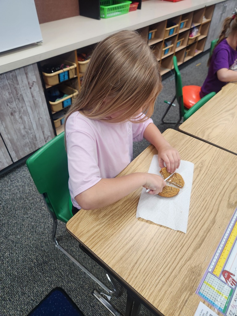 students practicing their fractions with oatmeal cream pies, they're cutting them and eating them too