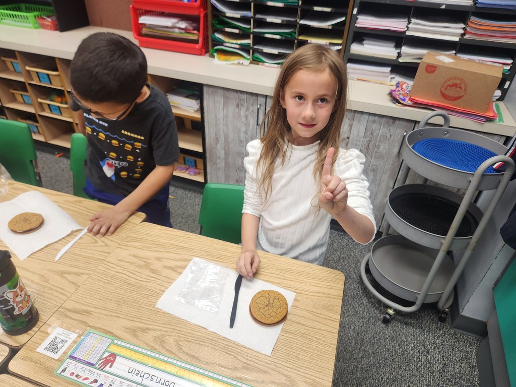 students practicing their fractions with oatmeal cream pies, they're cutting them and eating them too