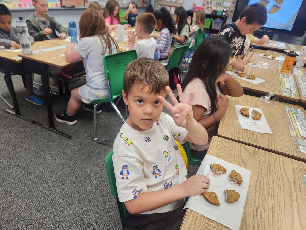 students practicing their fractions with oatmeal cream pies, they're cutting them and eating them too