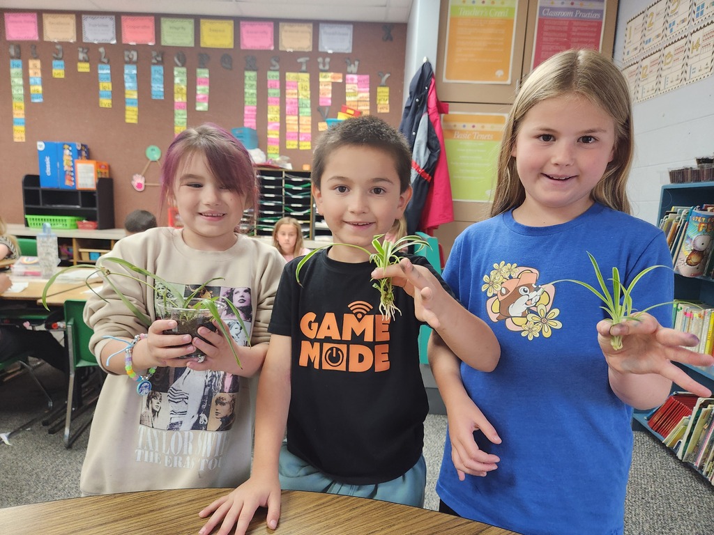 students holding plant
