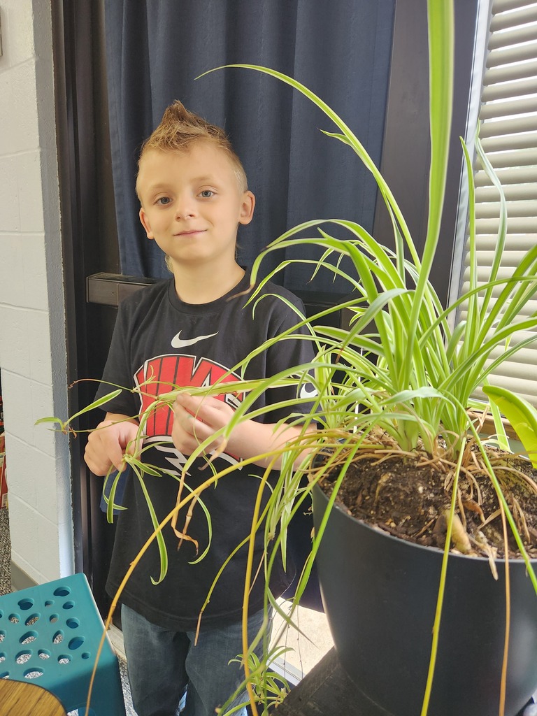 student holding plant