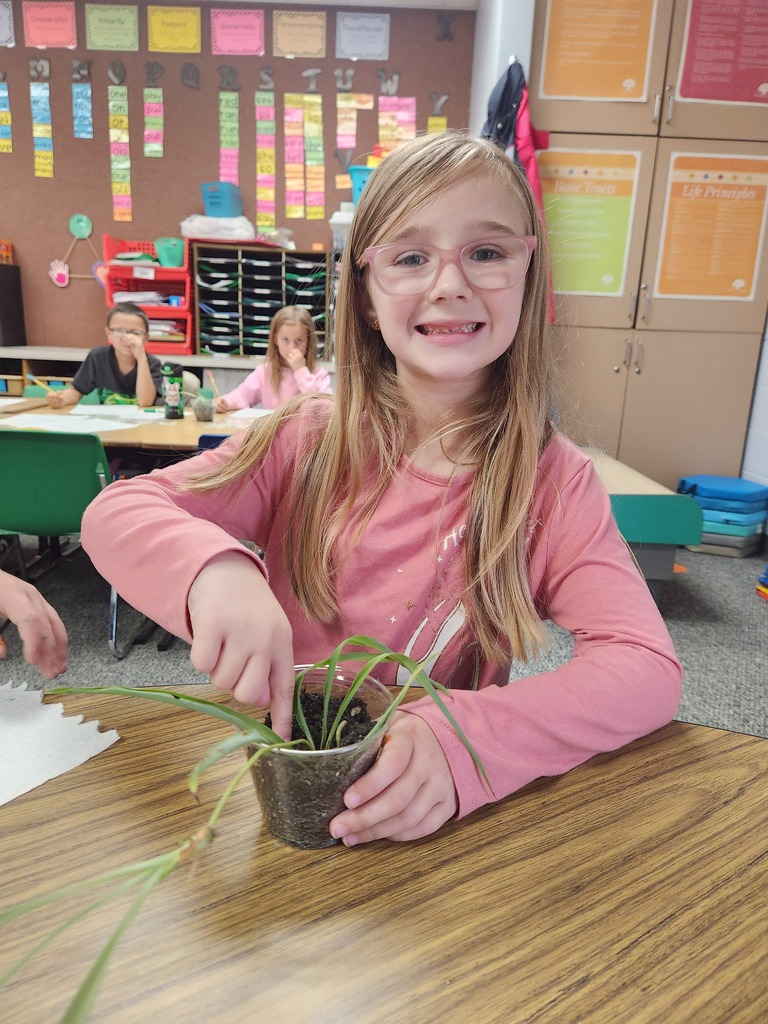student holding plant
