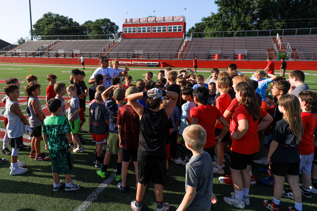 Coach Hurt with campers at Football Camp
