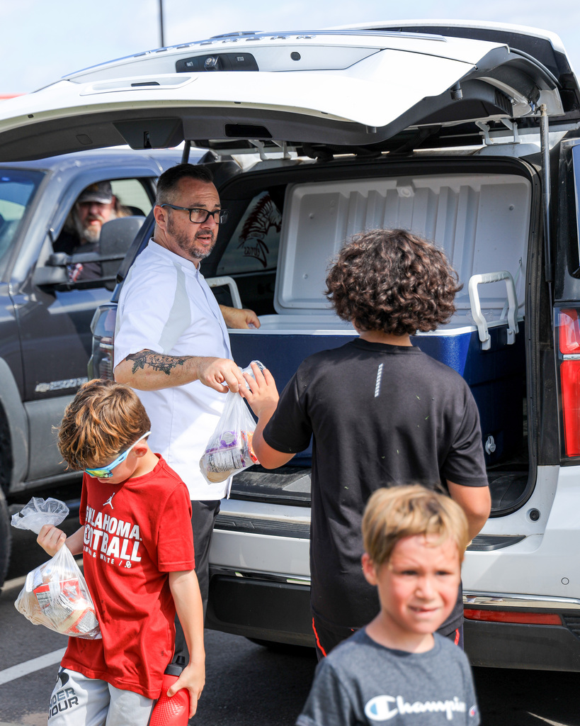 Chef Ryan feeding football campers.