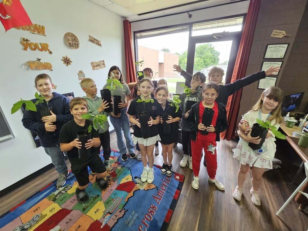 students with the plants they grew