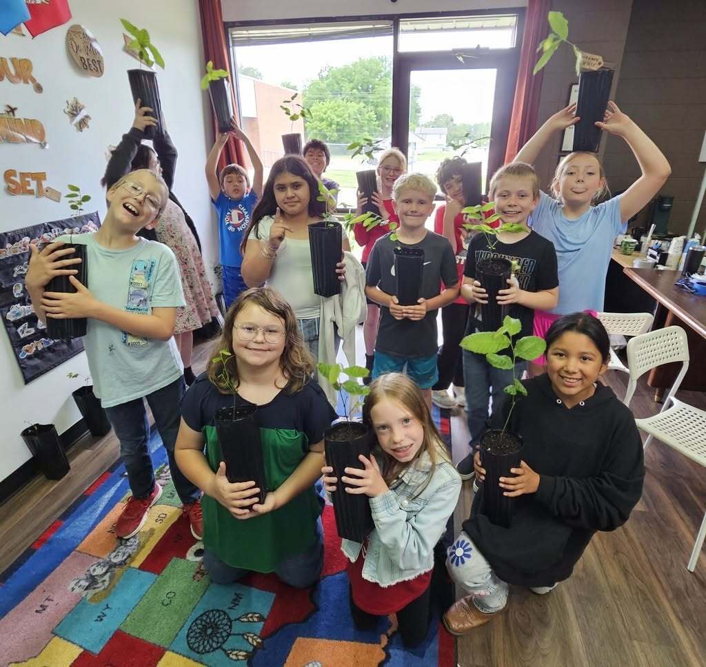 students with the plants they grew