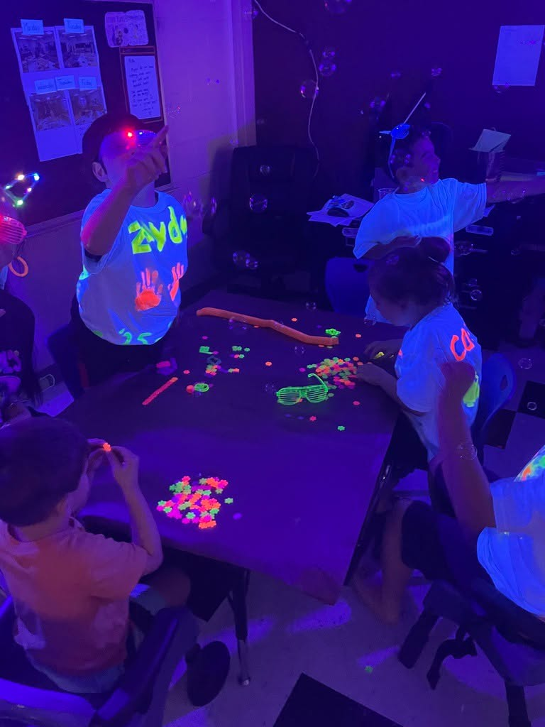 Elementary students celebrating the last day of school with a glow party