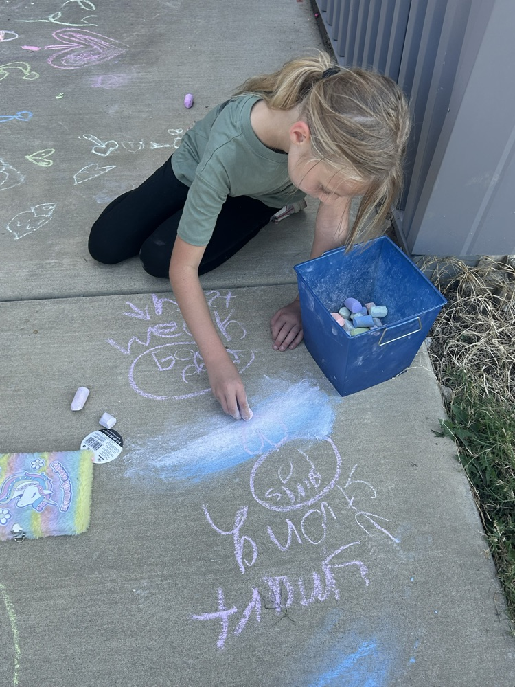 student drawing with chalk 