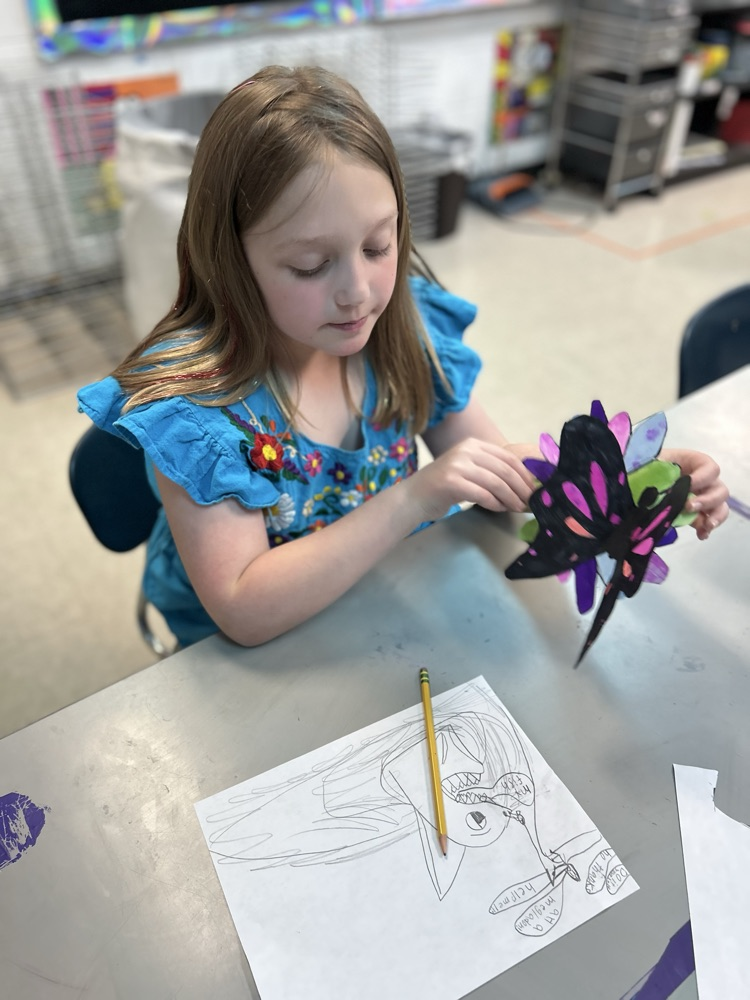 Student working hard in art.
