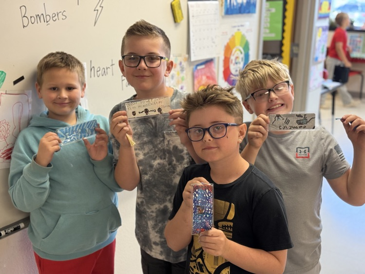 Students smiling with their new bookmarks