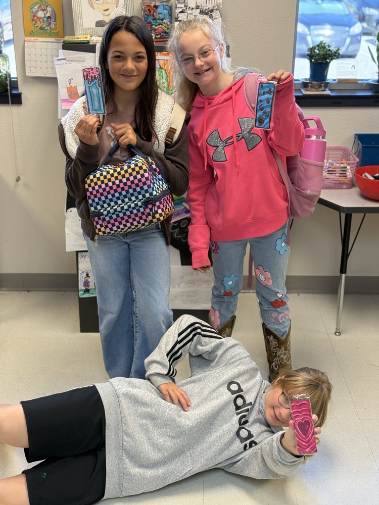 Students smiling while showing off their handy work.