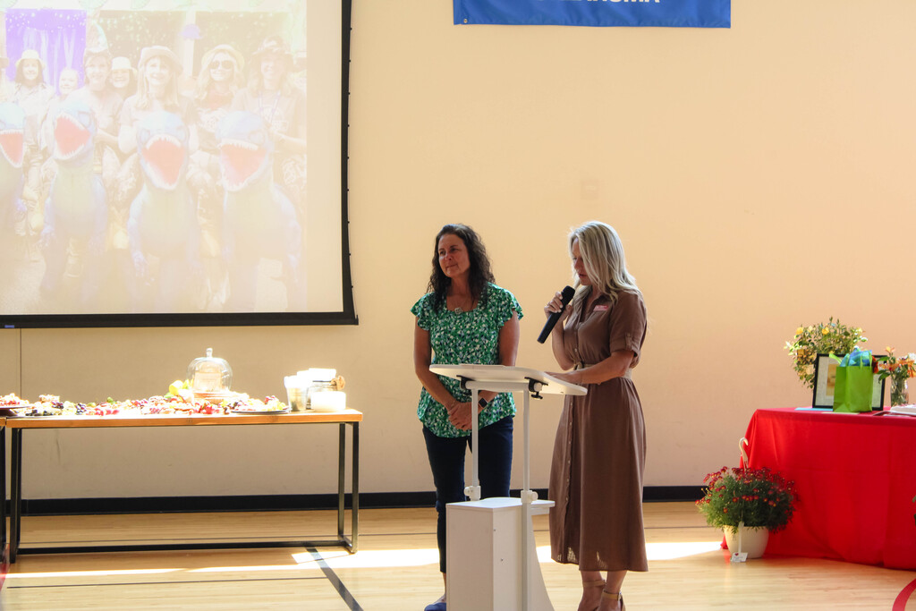 principal and lora siever in front of crowd giving speech