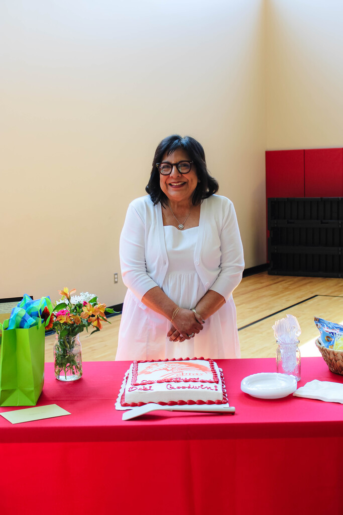 debi Goodwin smiling with her cake