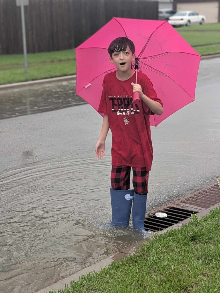 Kaysen playing in the rain