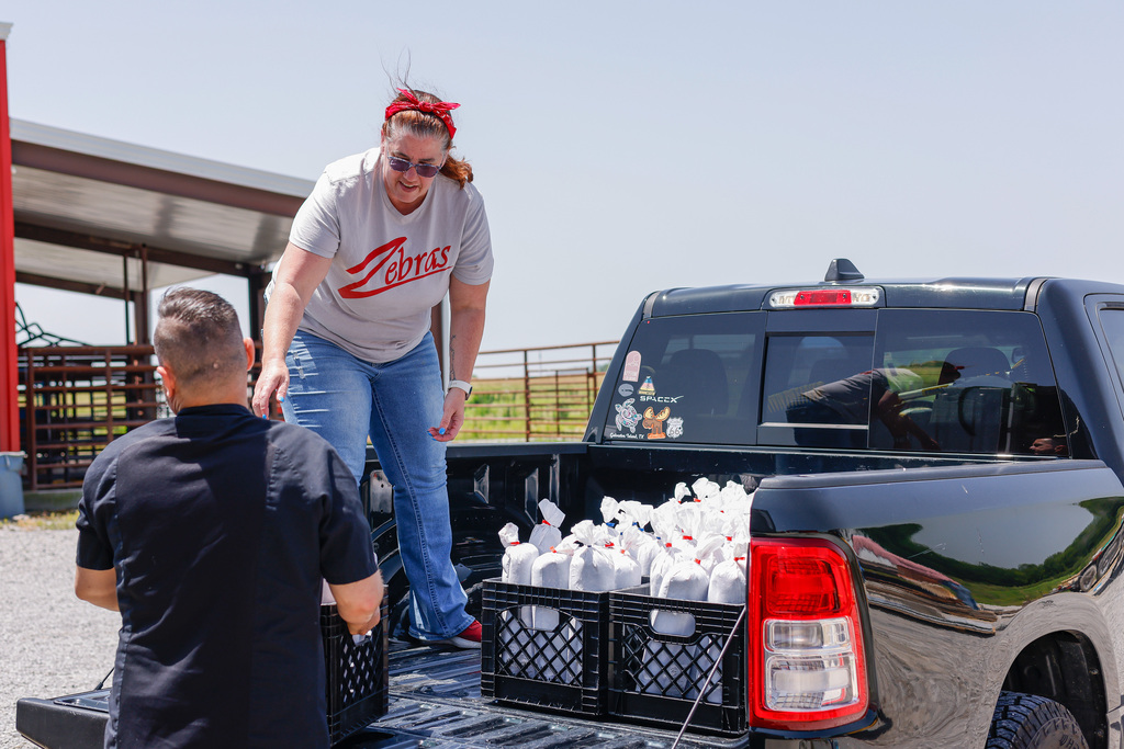 Ryan and Janna loading ground beef into truck bed