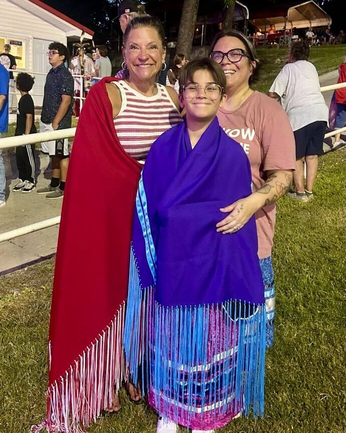 Mrs. Kropp with a student at the Quapaw Powwow