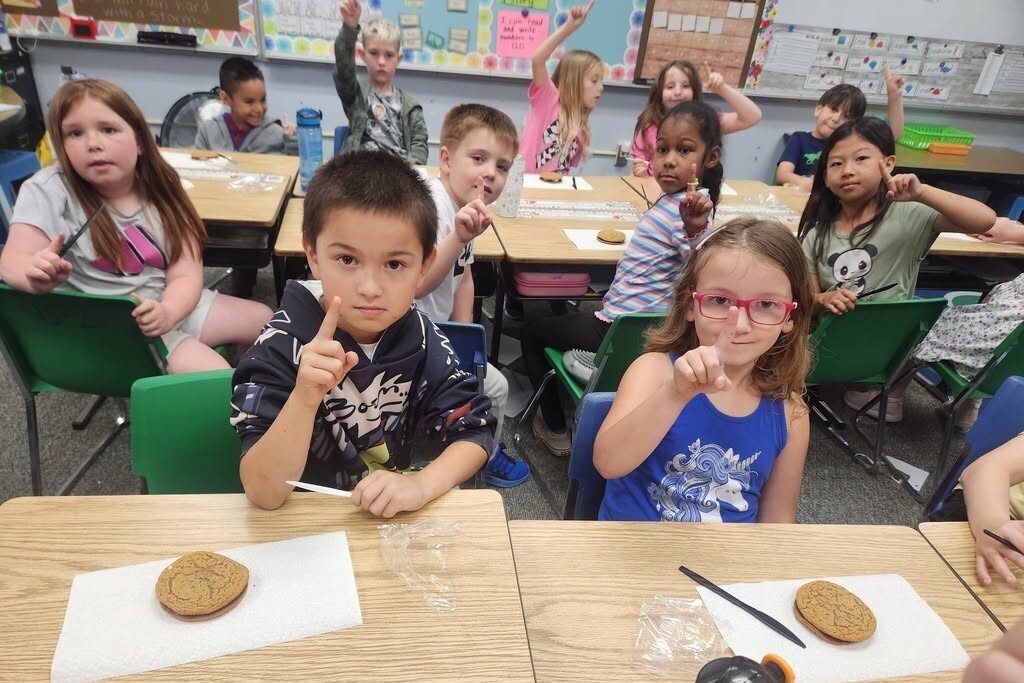 Elementary students learning about fractions with pies.