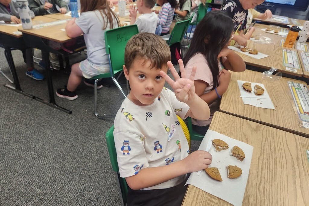 Elementary students learning about fractions with pies.