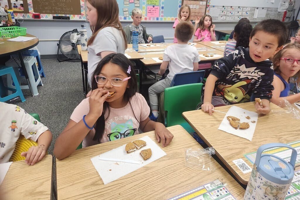 Elementary students learning about fractions with pies.