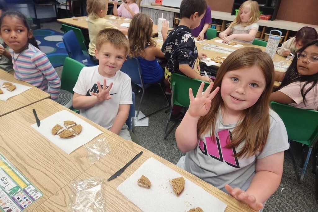 Elementary students learning about fractions with pies.