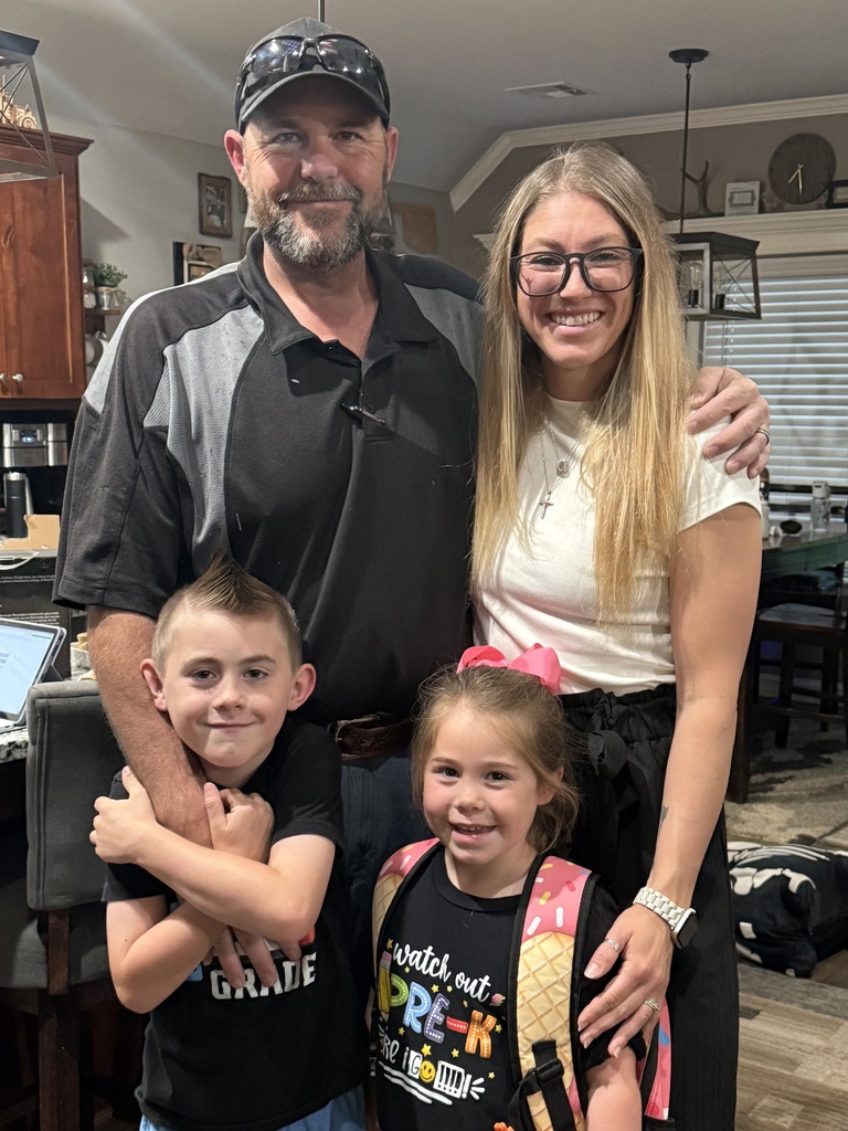 Mrs. Christenson with her husband and two child smiling