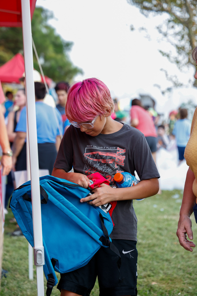 Boy unzipping his backpack to look inside