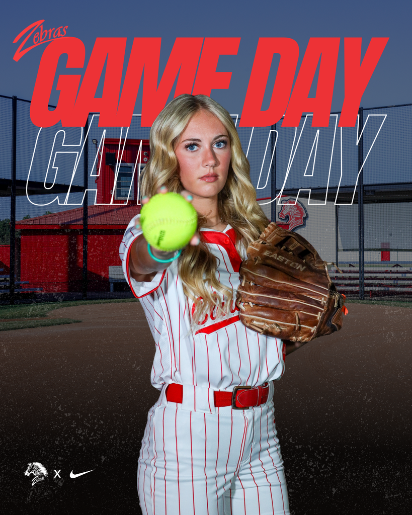 softball player holding softball on game day