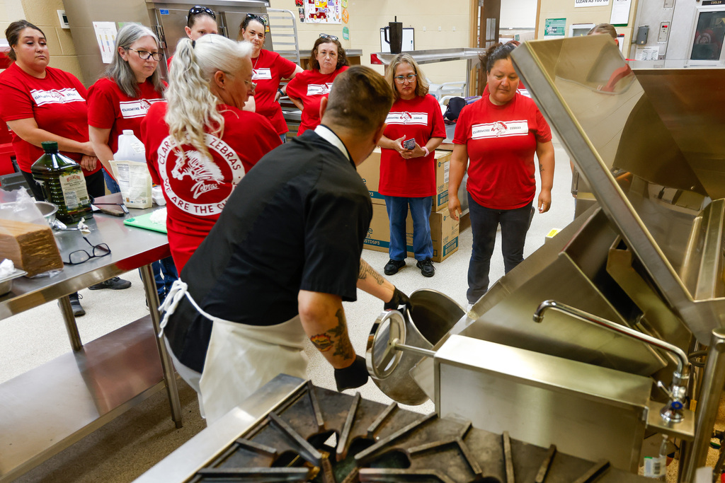 Chef Ryan training managers and cooks on new equipment.