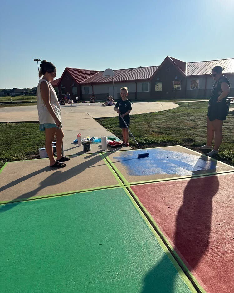 Catalayah parents and students repainting the sidewalks.