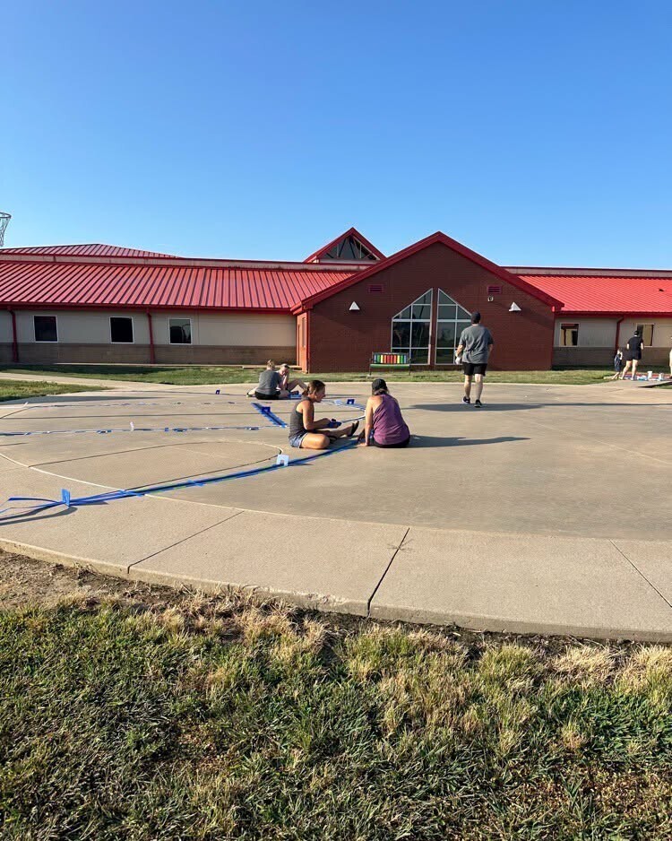 Catalayah parents and students repainting the sidewalks.