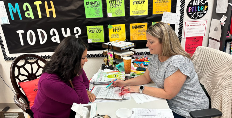 teacher going over grades with parent 