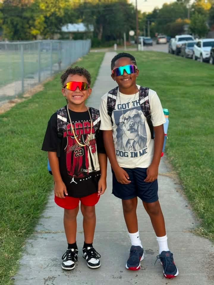 students smiling and wearing sunglasses