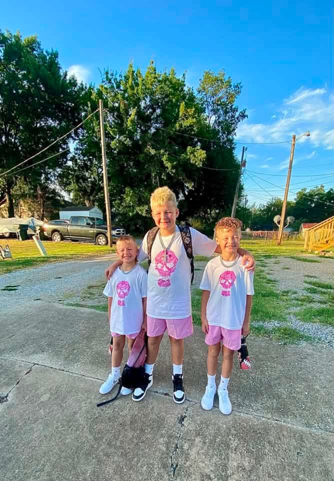 students dressed in shorts and t-shirts smiling 