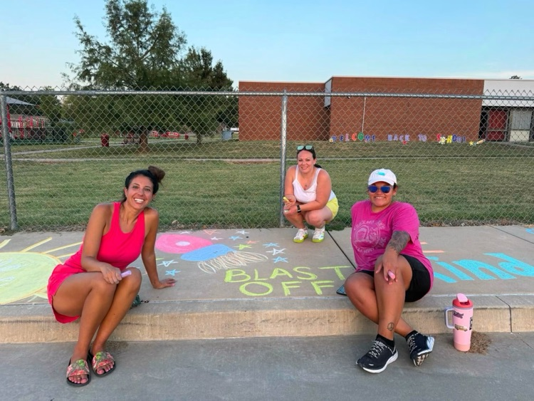 PTO members decorating the sidewalk