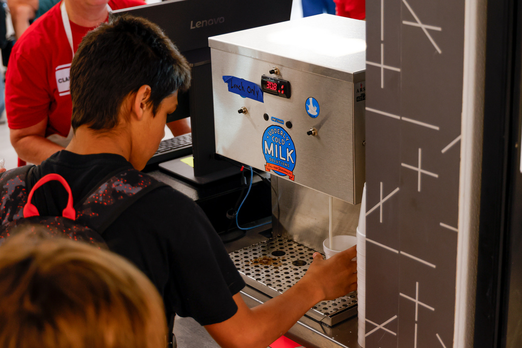 Junior high students using new milk machine