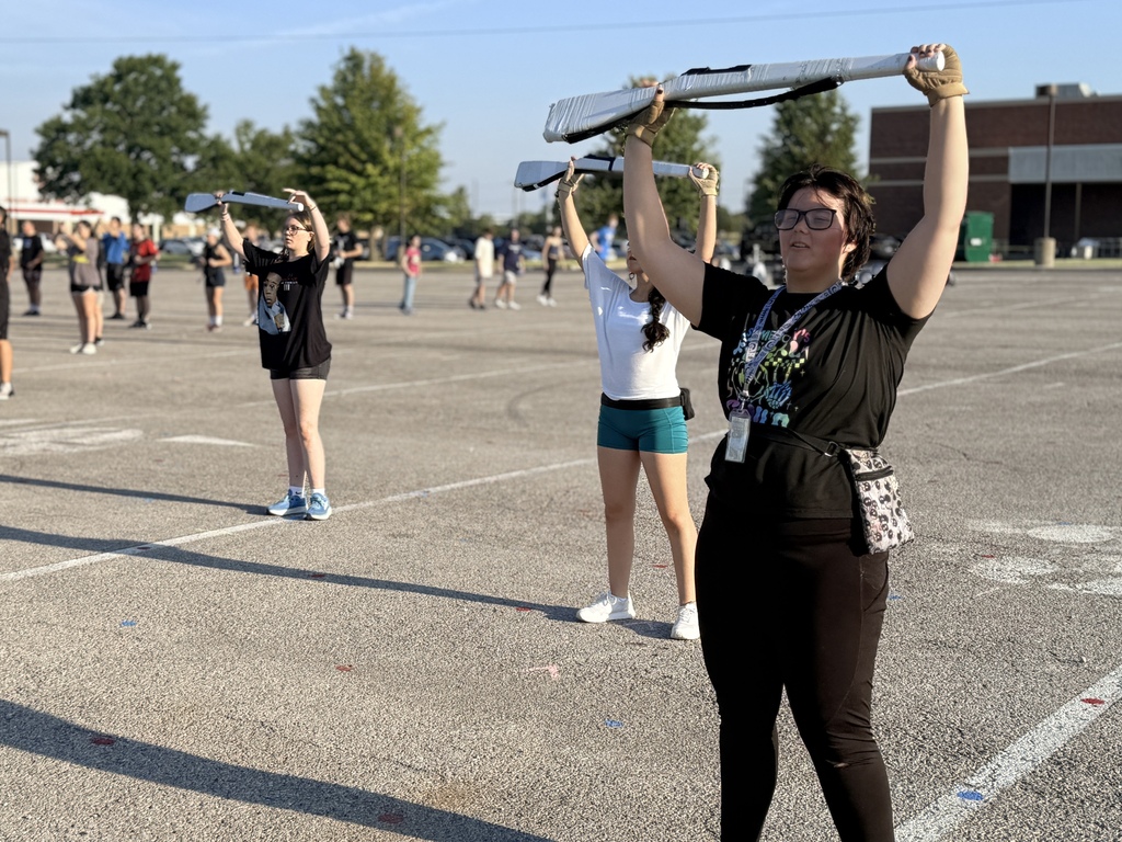 Colorguard working on their spinning for contest.