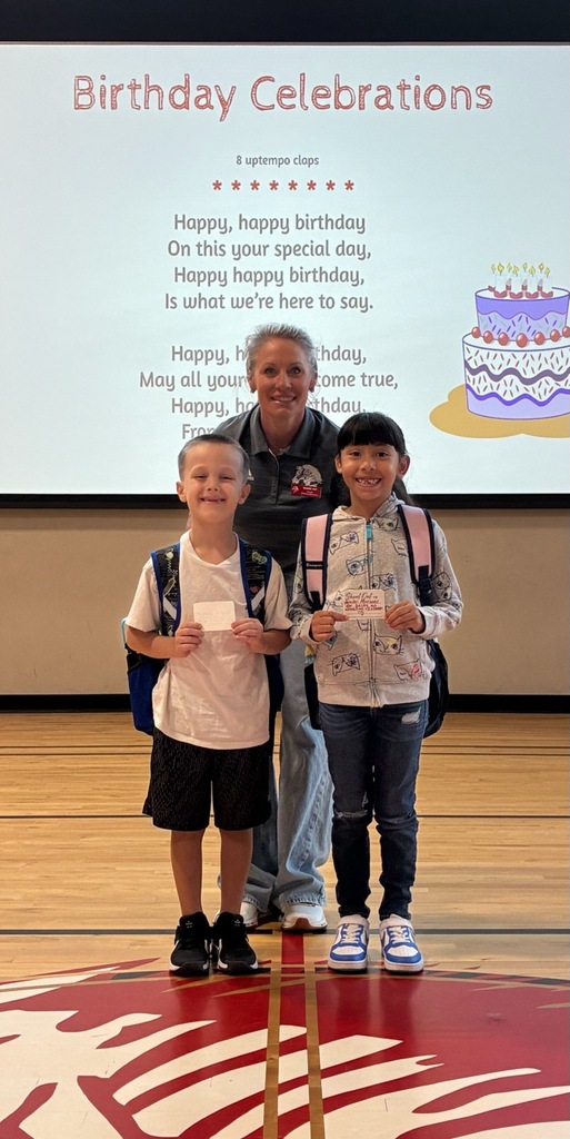 students smiling with their shout out cards