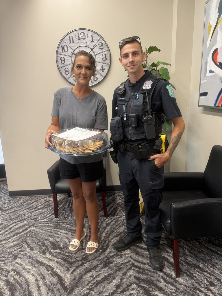 SRO and woman standing with a platter of cookies