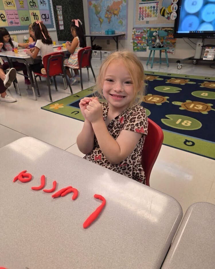 First grade students making their names out of playdough.
