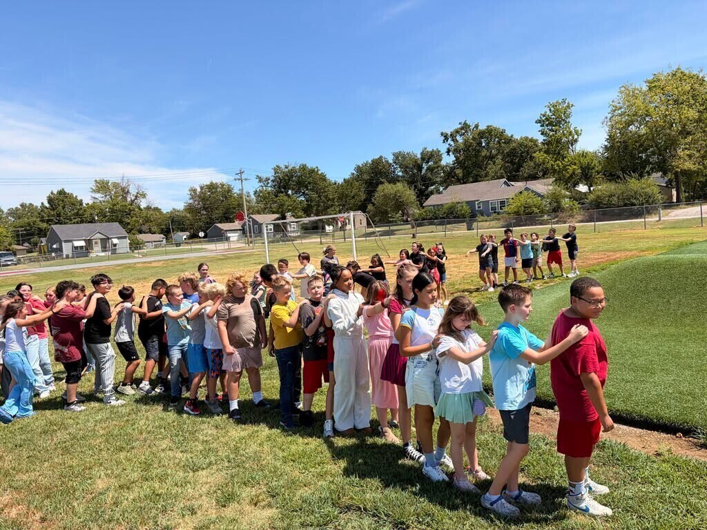 Elementary students working on team bonding with caterpillar.