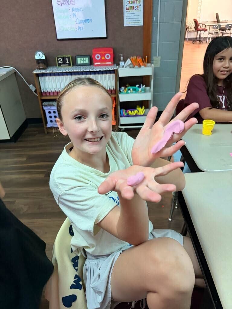 Elementary students working on team bonding with caterpillar.