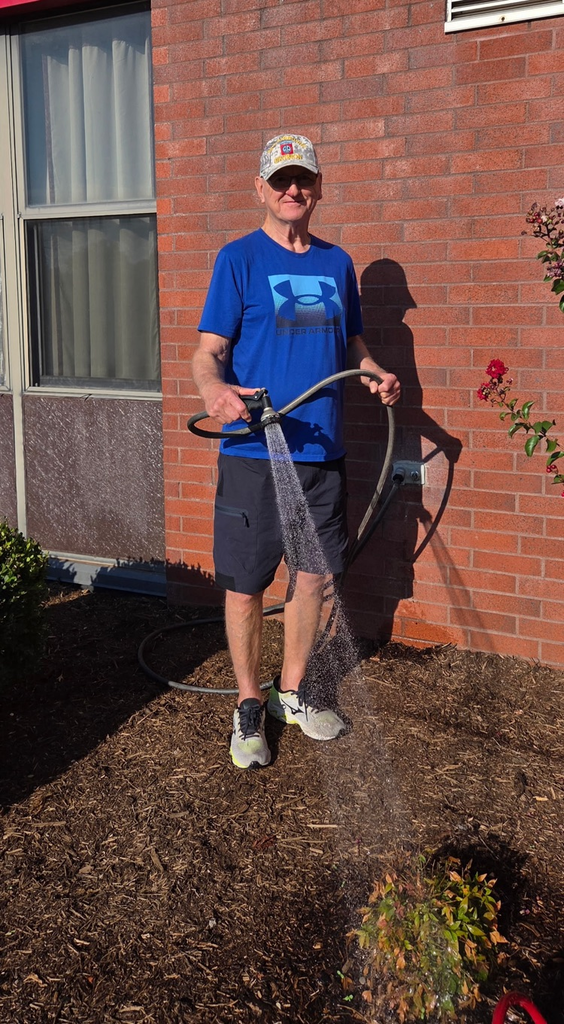 Mr. McGuire watering plants